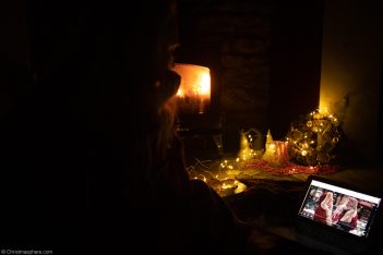 watching christmas movie on the laptop by the fire wearing pyjamas