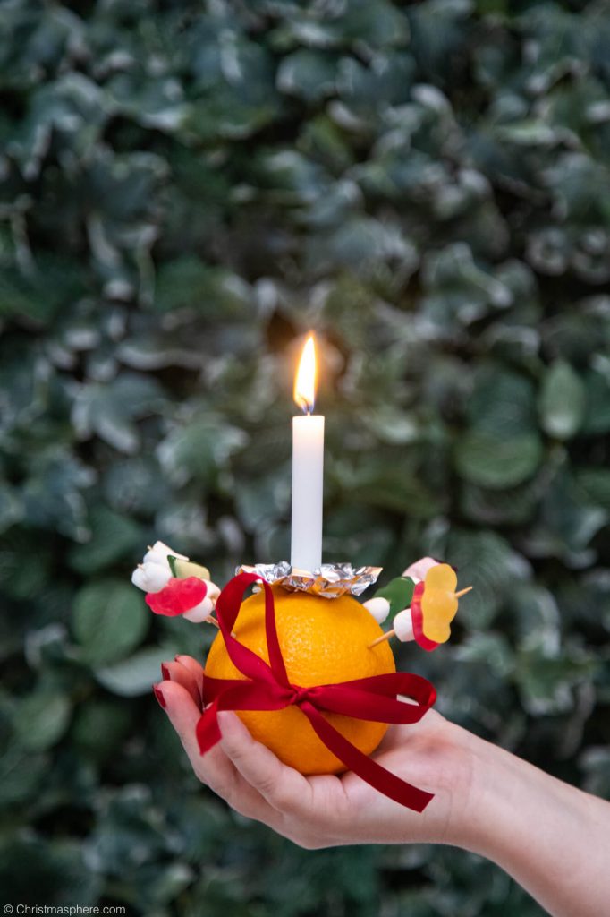 holding a Christingle candle