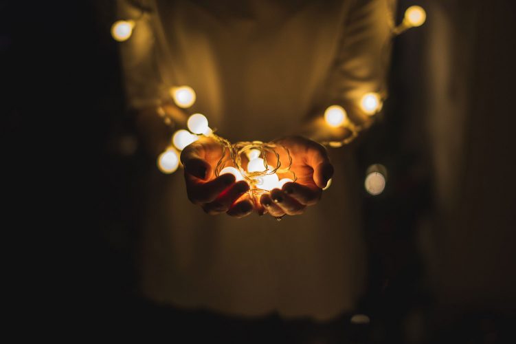 Hands holding fairy lights