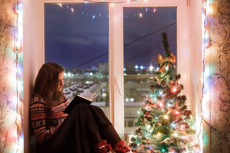 girl reading Christmas novels