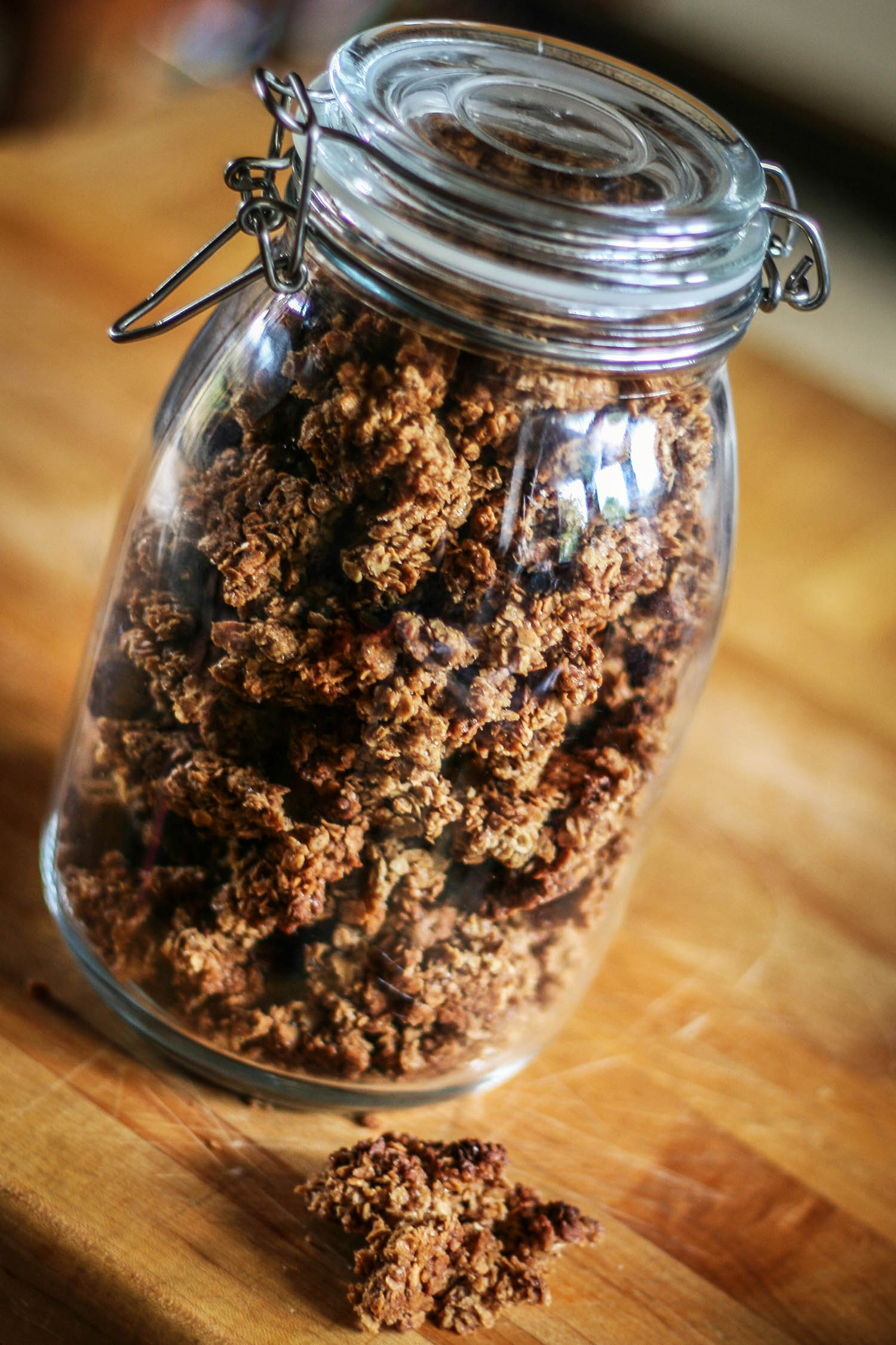 Large glass jar containing pieces of homemade granola