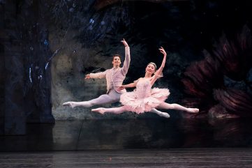 two ballet dances in a synchronised leap